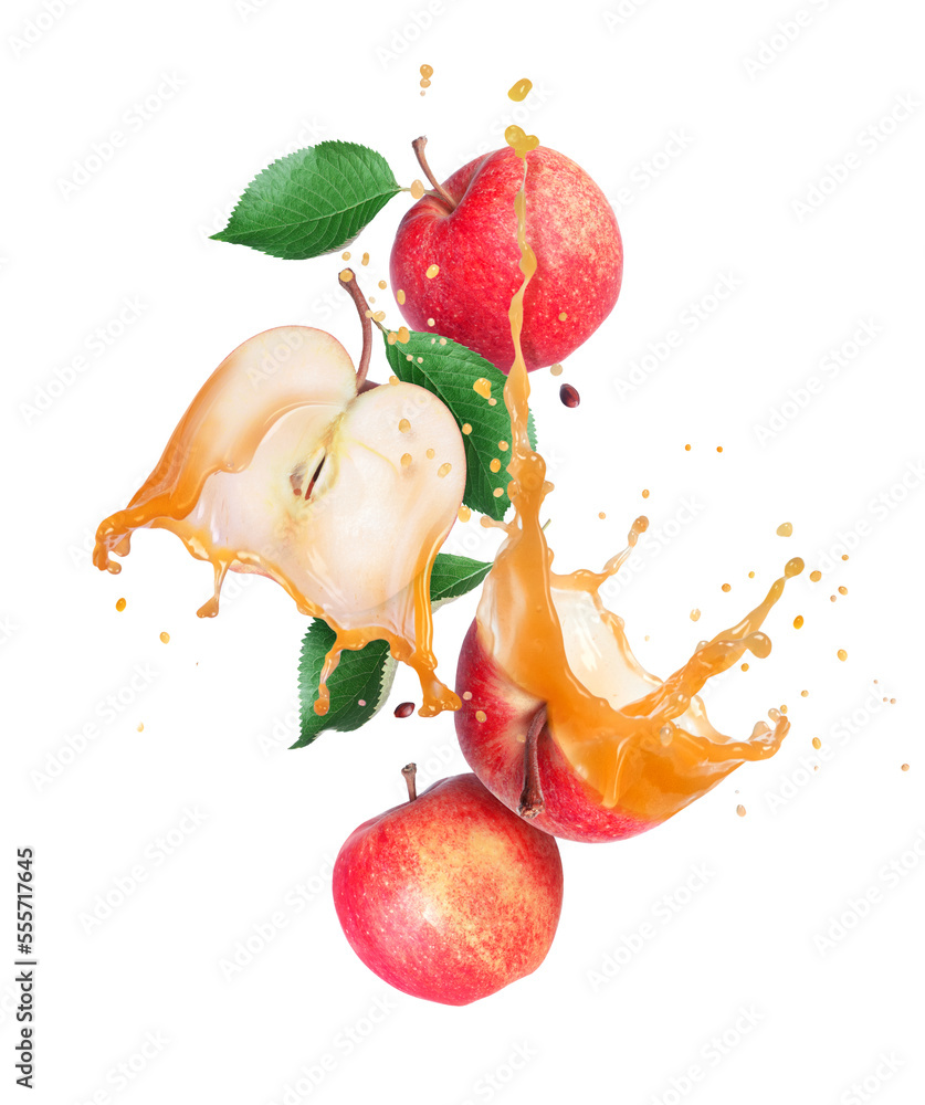 Whole and sliced ​​ripe apples with leaves with splashes of juice in the air