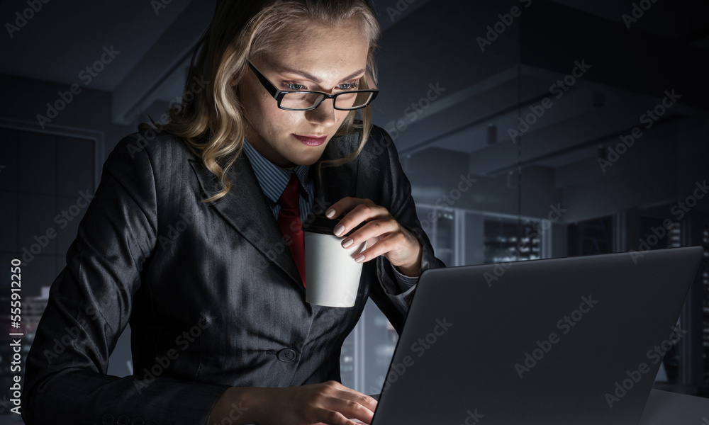 Businesswoman at desk looking at laptop