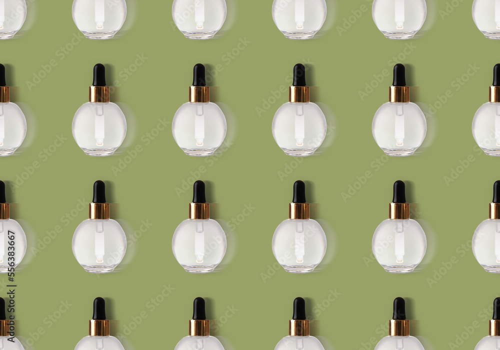 Many bottles of essential oil on color background. Pattern for design