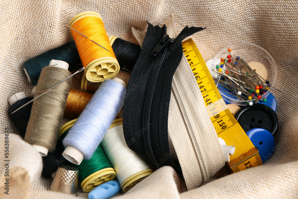 Cloth with different sewing supplies, closeup