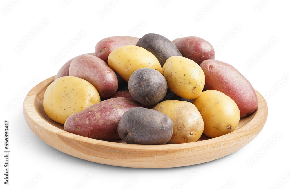 Wooden plate with different types of raw potatoes on white background