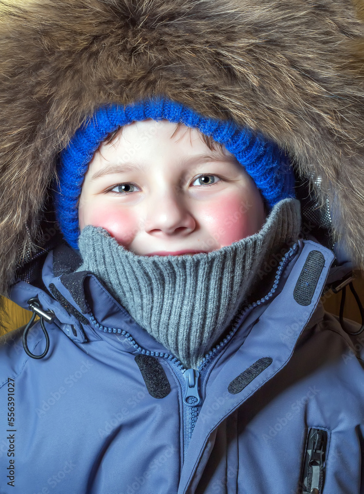 Portrait of a ten-year-old boy dressed in casual warm winter clothes. Frosty weather