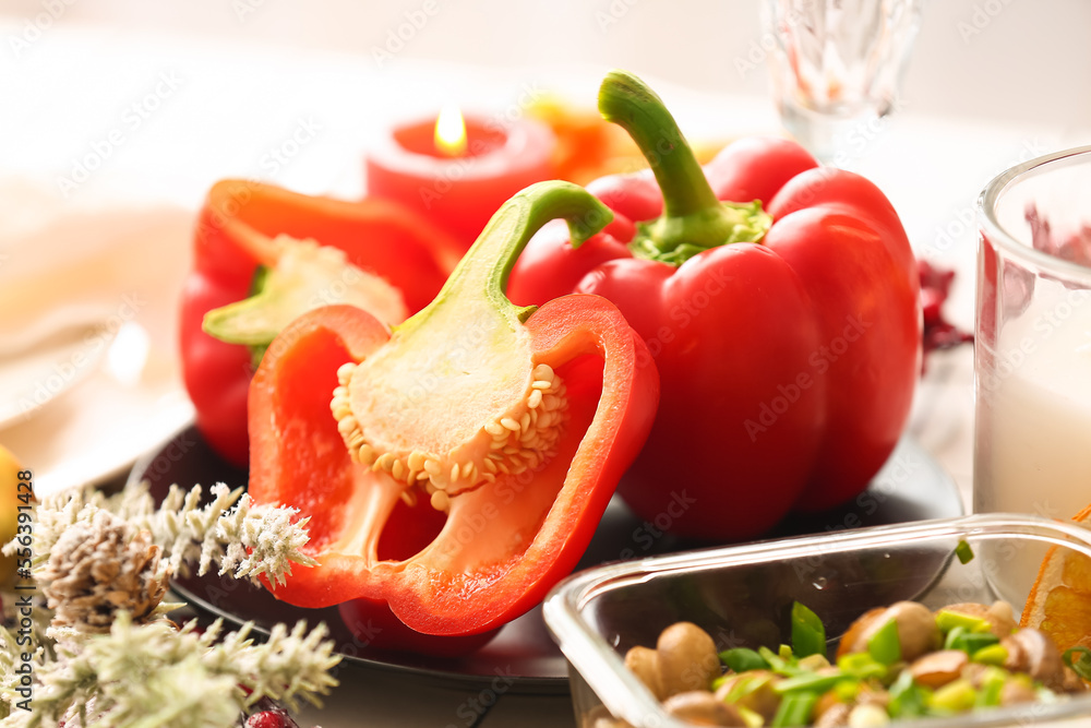 Christmas table setting with bell peppers in dining room, closeup