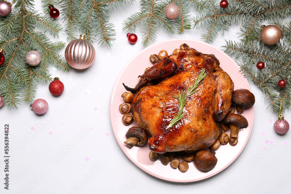 Plate with tasty chicken, mushrooms, Christmas branches and balls on white background