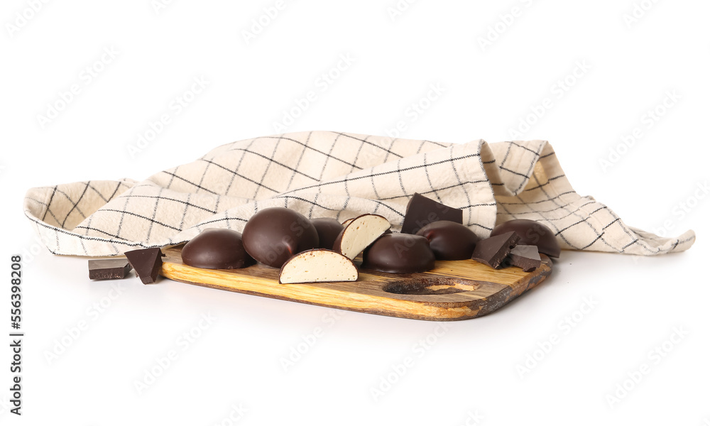 Cutting board with sweet chocolate birds milk candies on white background