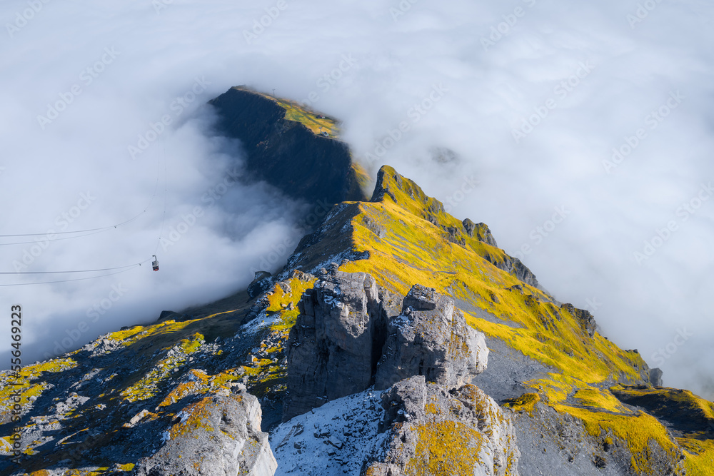 Mountains and clouds in the valley. Natural landscape high in the mountains. Cableway in the mountai