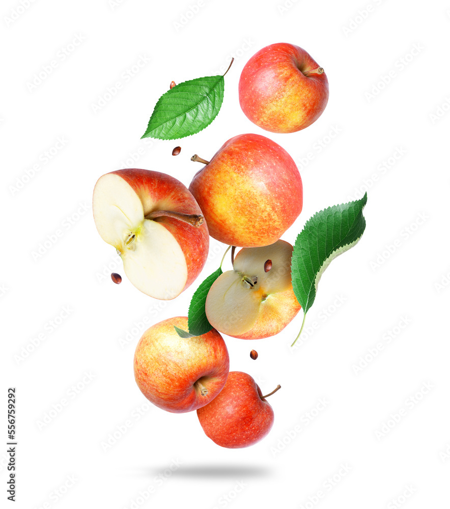 Whole and sliced ​​ripe apples with green leaves in the air closeup on a white background