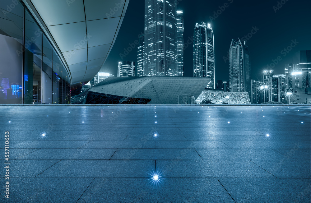 Panoramic skyline and modern commercial buildings with empty square floor in Guangzhou at night, Chi