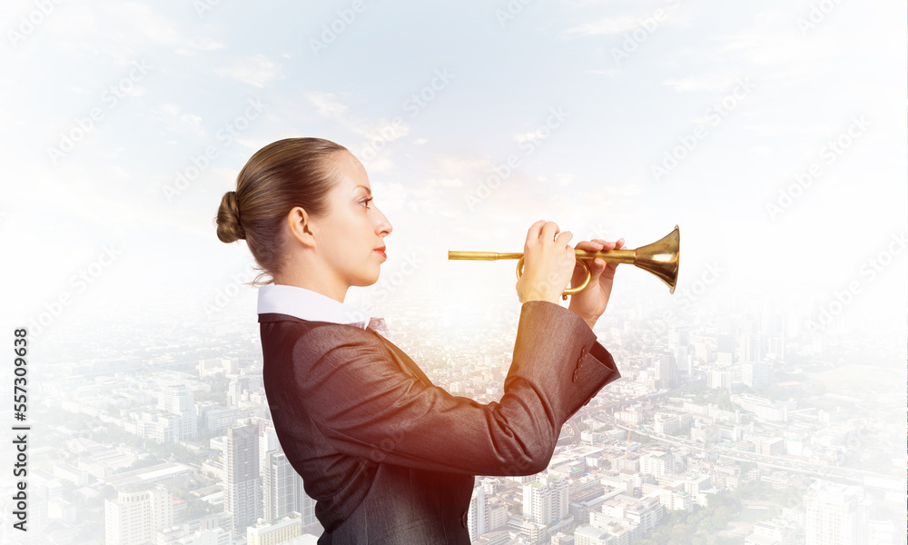 Business woman playing the trumpet