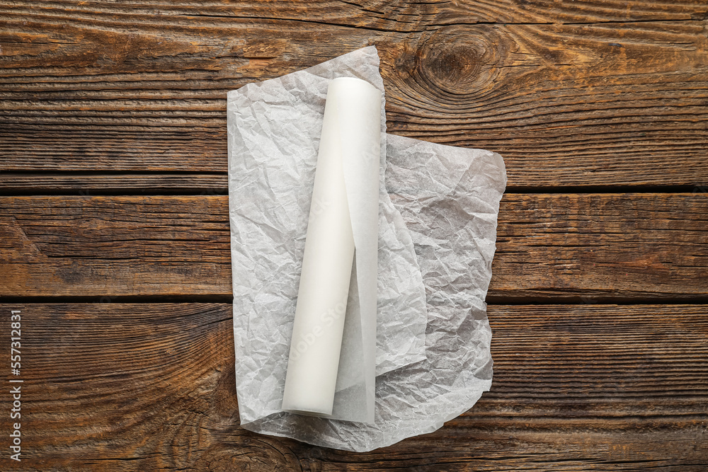 Baking paper on dark wooden background