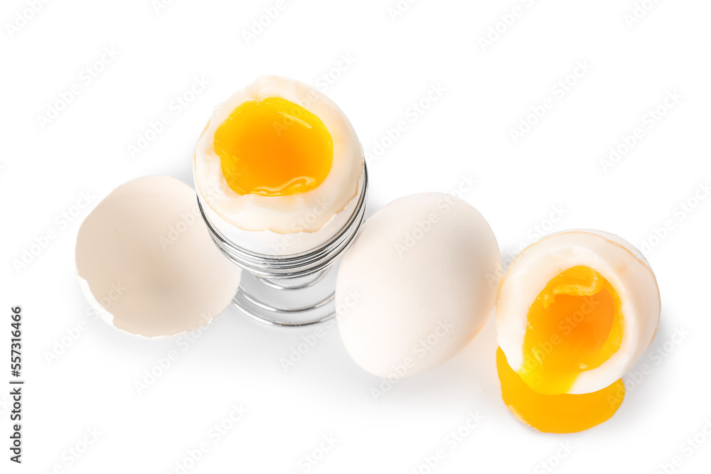 Soft boiled eggs, holder and shell on white background