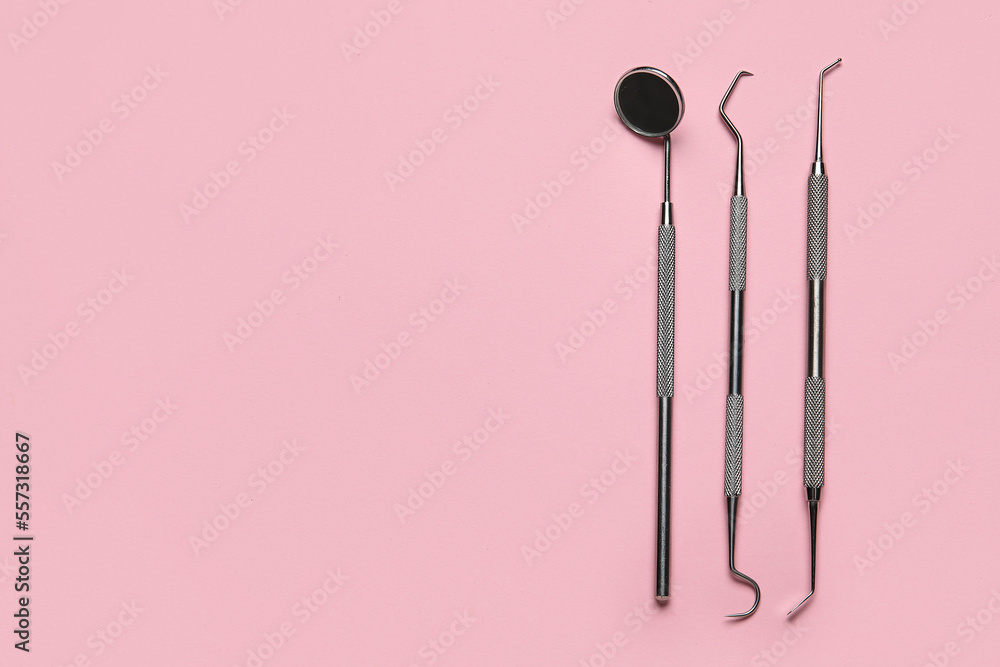 Dental tools on pink background