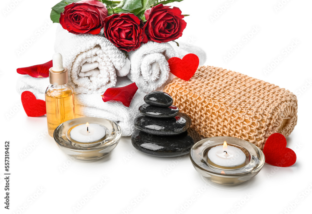 Spa composition for Valentines Day with stones, candles and roses on white background