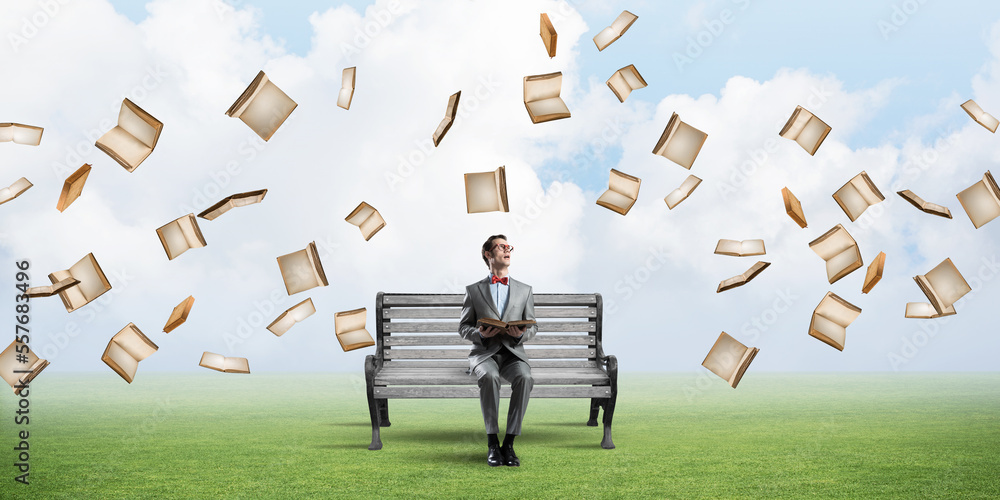 Young businessman or student studying the science and books fly around