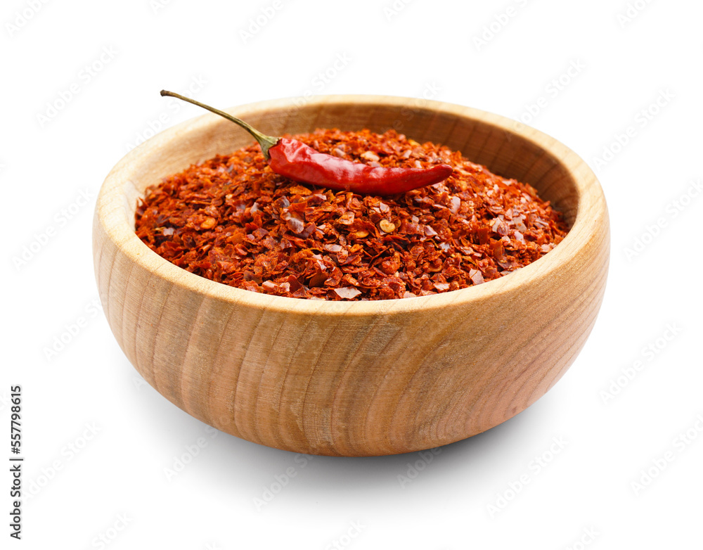 Wooden bowl of chipotle chili flakes on white background