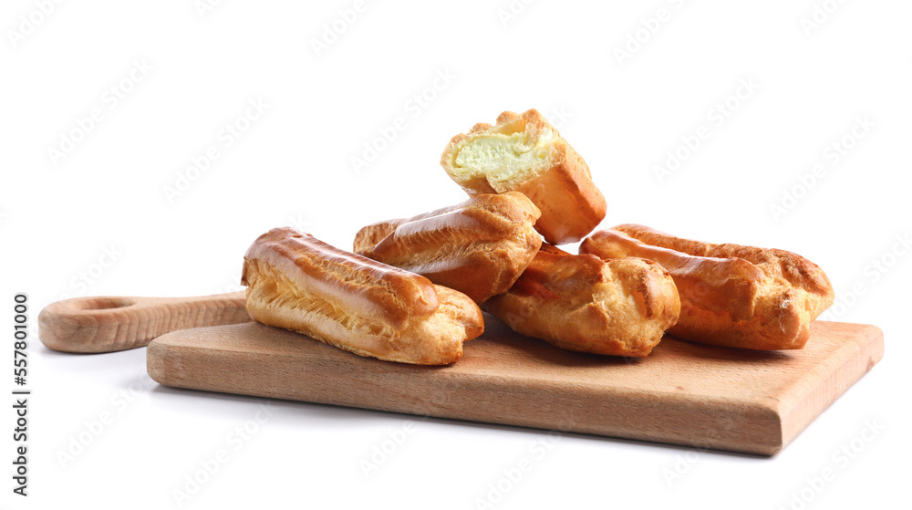 Wooden board with sweet eclairs on white background