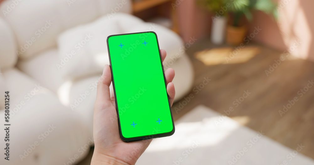 woman hold green screen mobile