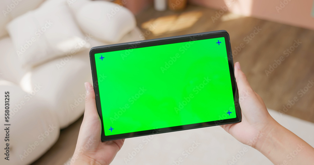 woman hold green screen touchpad