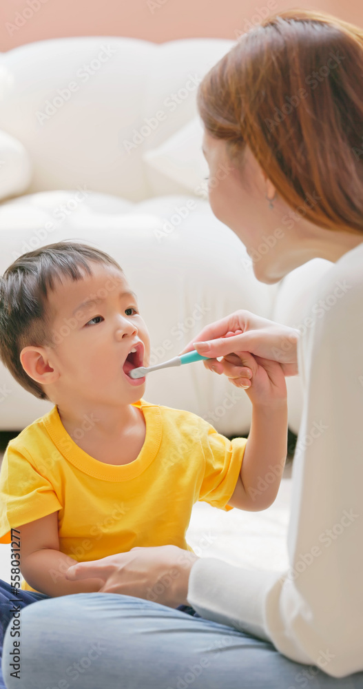 mom and son brush teeth