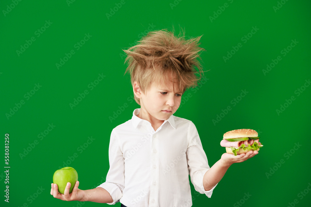 Surprised child against green chalkboard in class