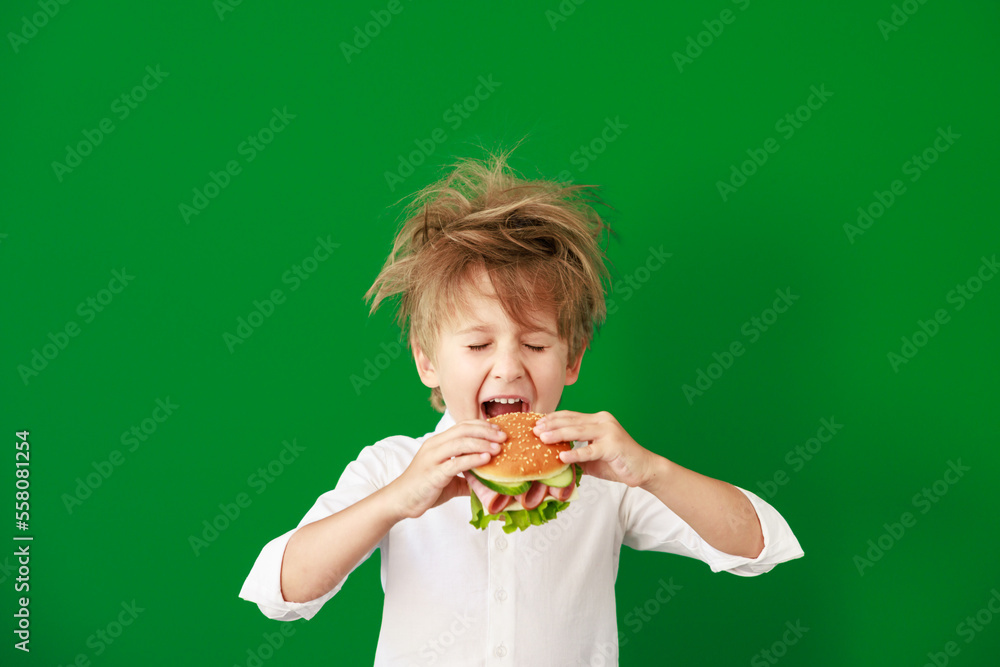 Surprised child against green chalkboard in class