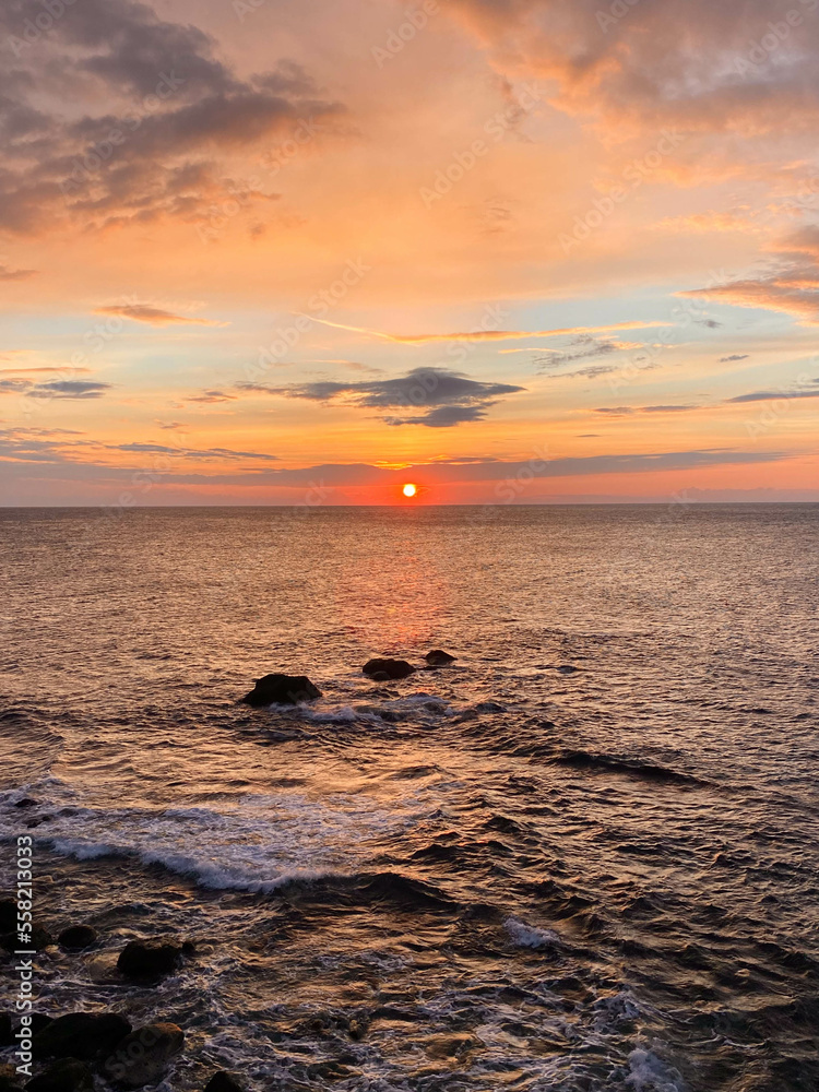 colorful sunset at sea with rocks