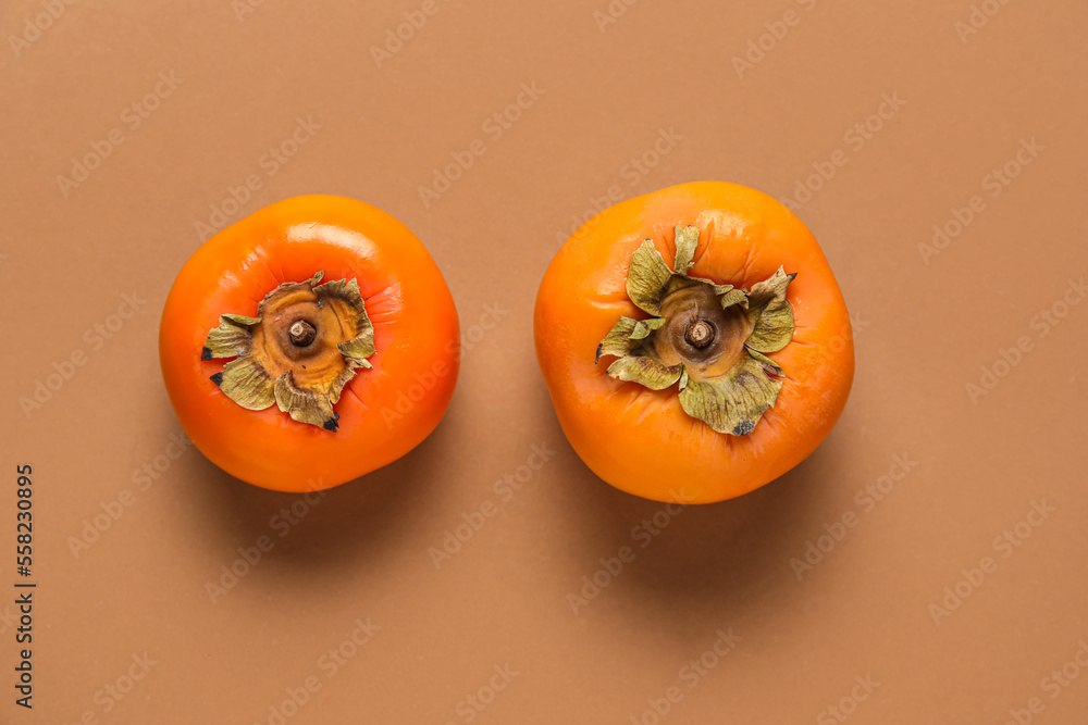 Fresh persimmons on color background