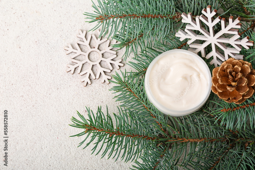 Composition with jar of cream, Christmas decor and fir branches on light background