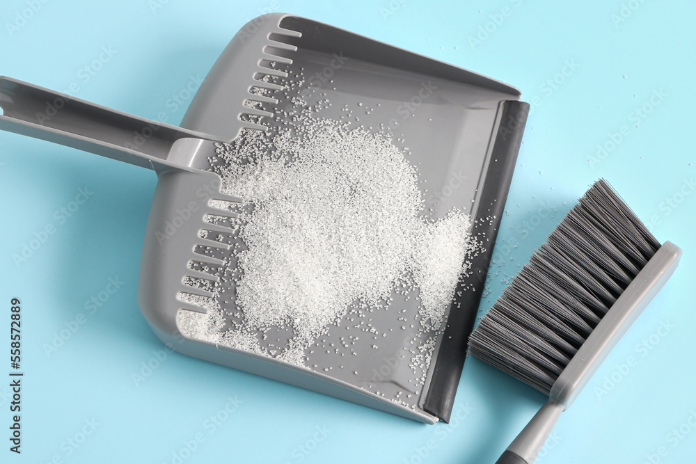 Dustpan with sugar and brush on color background, closeup