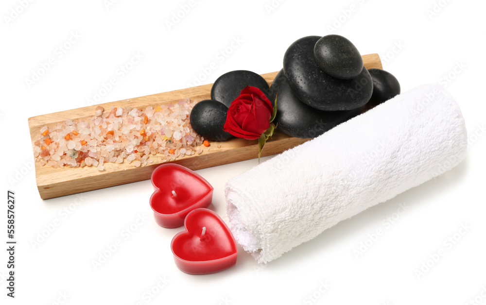 Beautiful spa composition for Valentines Day with rose, sea salt, towel, candles and stones on whit