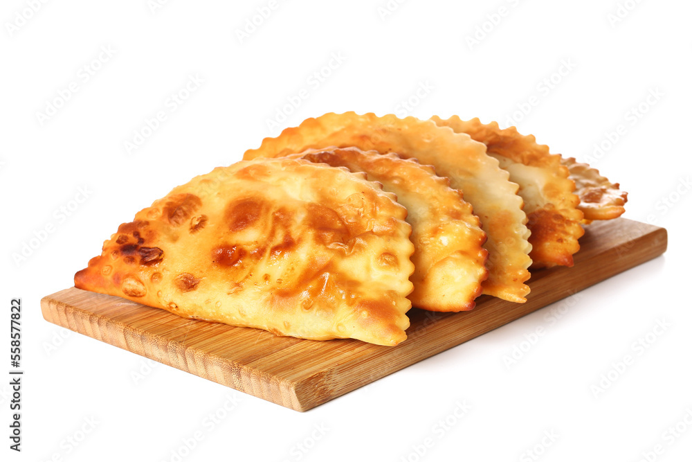 Wooden board with tasty chebureks on white background