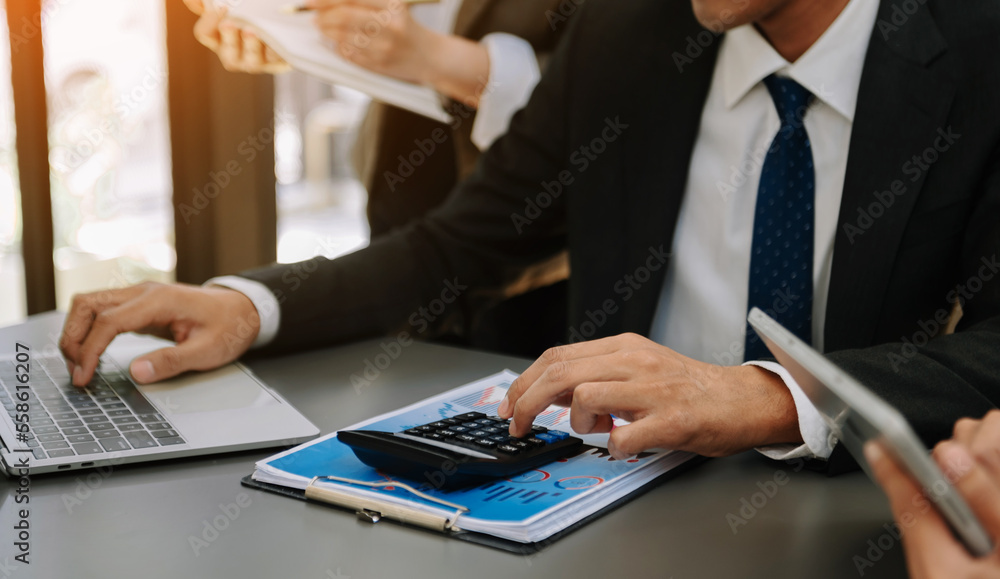 Businessman or accountant hand typing laptop working to calculate on desk about cost at home office.