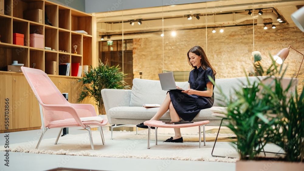 Portrait of Smiling Caucasian Woman Working on a Laptop in a Meeting Room at Office. Female Team Lea