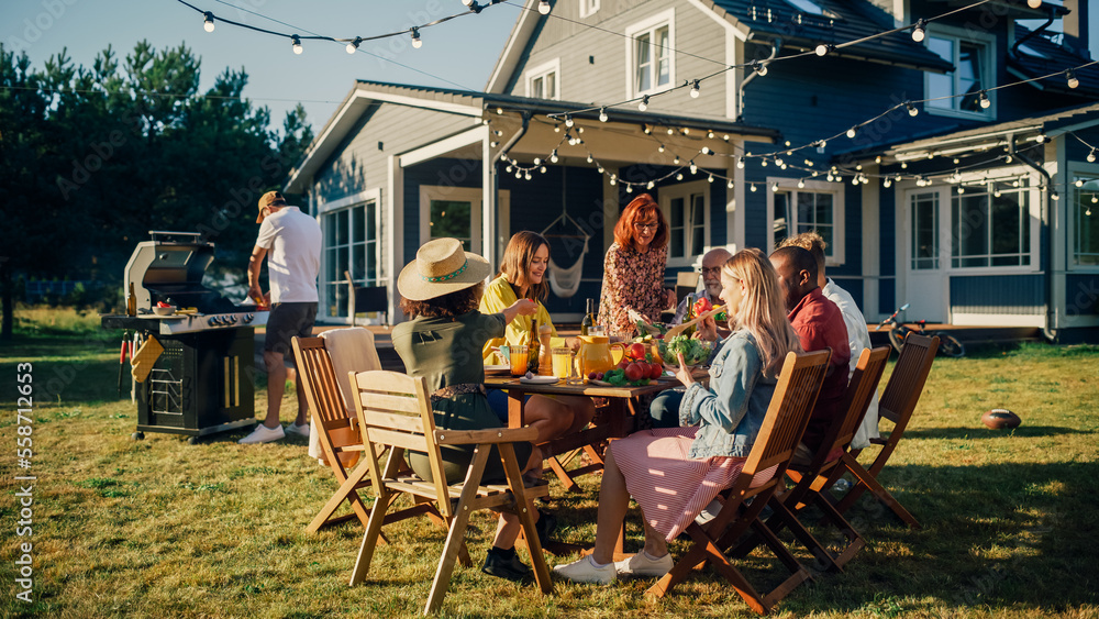 Parents, Children and Friends Gathered at a Barbecue Dinner Table Outside a Beautiful Home. Old and 