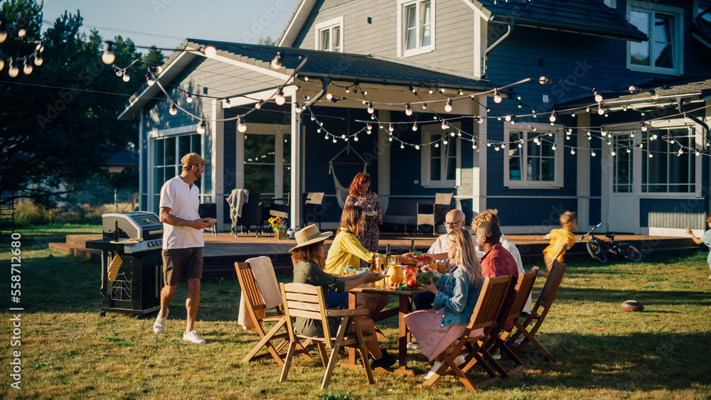 Family and Multiethnic Diverse Friends Gathering Together at a Garden Table. People Cooking Meat on 