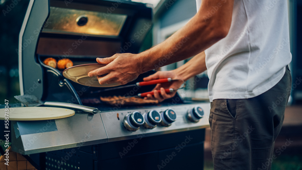 Close Up Man Preparing Grilled Meat Steak on a Fire Grill. Young Man Grilling Food for Outdoors Barb