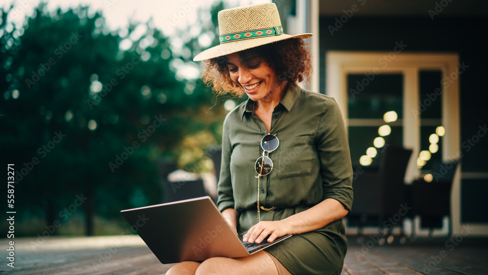 Portrait of a Positive Multiethnic Female Using Laptop Computer on a Porch of a House. Young Female,