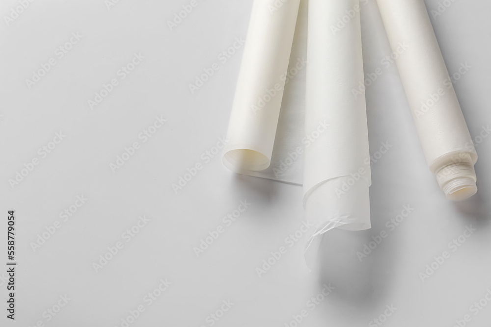 Rolls of baking paper on white background