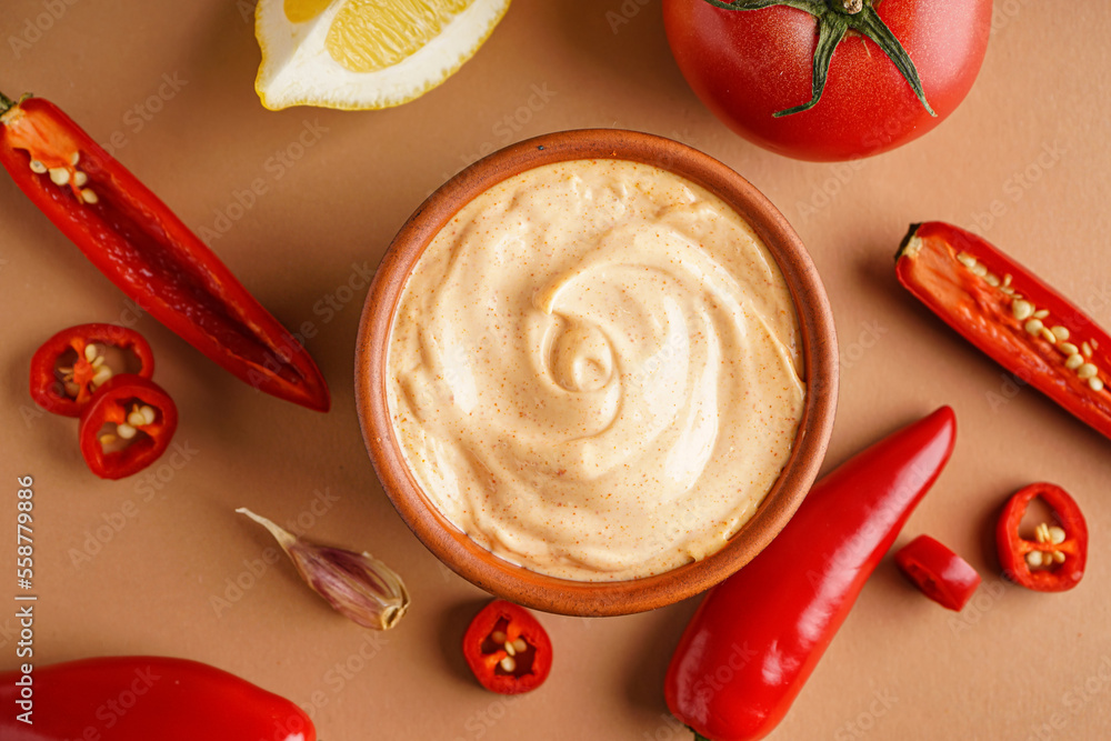 Bowl of tasty chipotle sauce and fresh jalapeno on color background