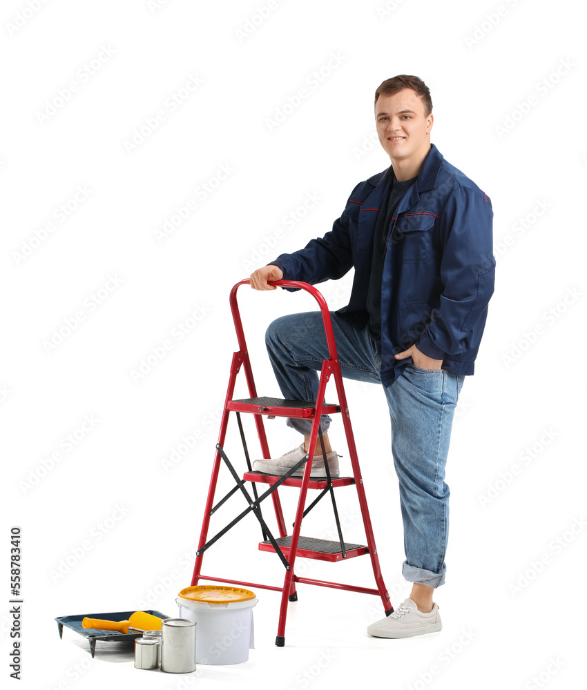 Young man with ladder and cans of paint on white background