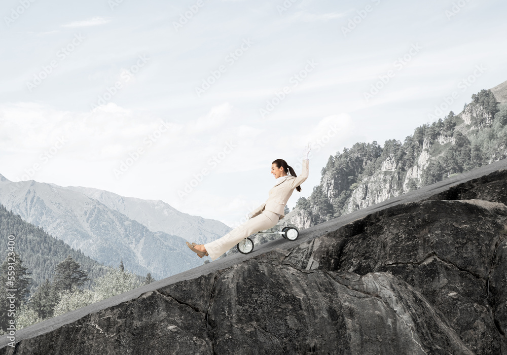 Beautiful happy woman riding downhill