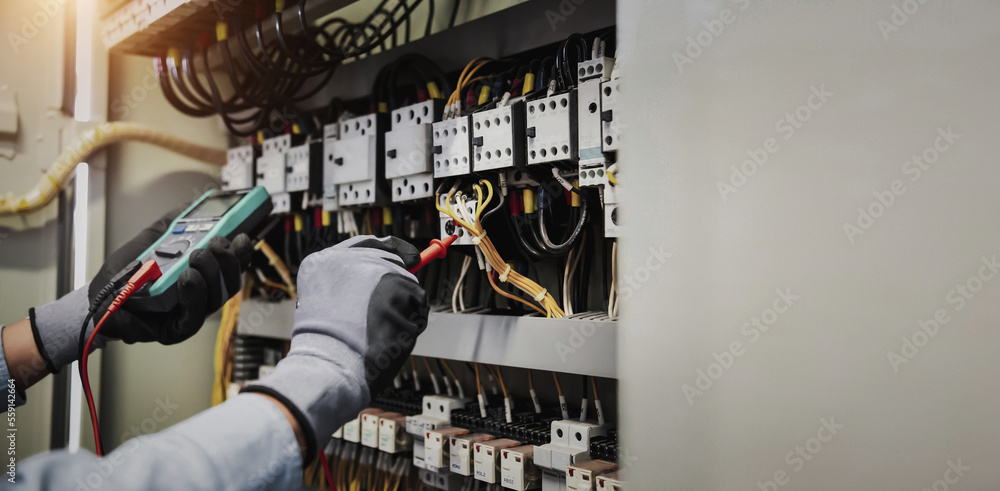 Electricity and electrical maintenance service, Engineer hand holding AC multimeter checking electri