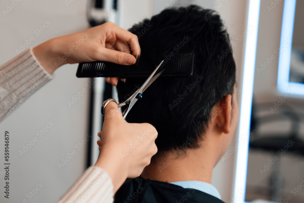 Closeup asian female barber making haircut for male customer with male hairstyle in qualified barber