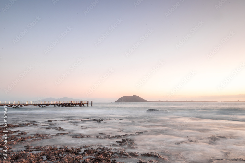 Beautiful morning on the sandy beach. Long exposure at the sea. Milky sunrise in haze and fog. Corra