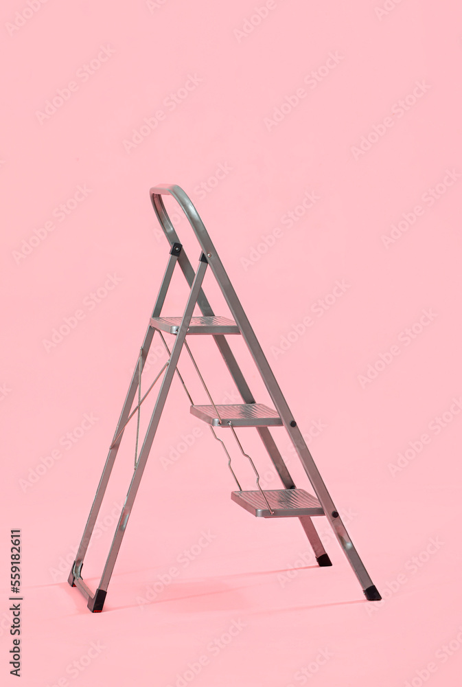 Maintenance ladder on pink background