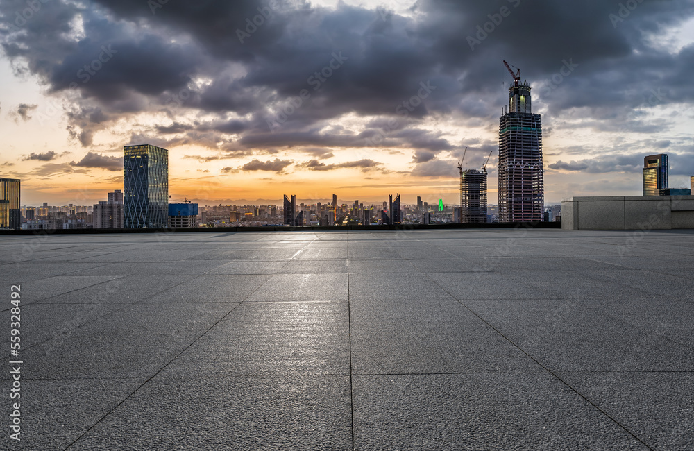 Empty square floor and modern city skyline with buildings at sunset in Ningbo, Zhejiang Province, Ch