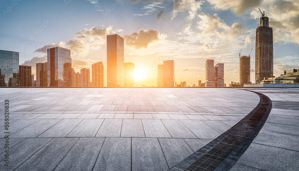 Empty square floor and modern city skyline with buildings at sunset in Ningbo, Zhejiang Province, Ch