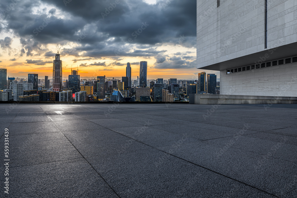 Empty square floor and modern city skyline with buildings at sunset in Ningbo, Zhejiang Province, Ch