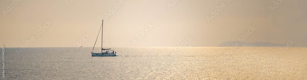 Windsurfing at sunset beatiful golden Sea horizon view. Golden Sea at Sunset with Windsurf board Sun