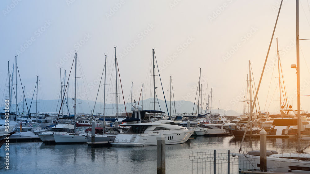 a lot Fashionable Luxury yachts docked in sea port at sunset for Vacation. Marine parking of modern 